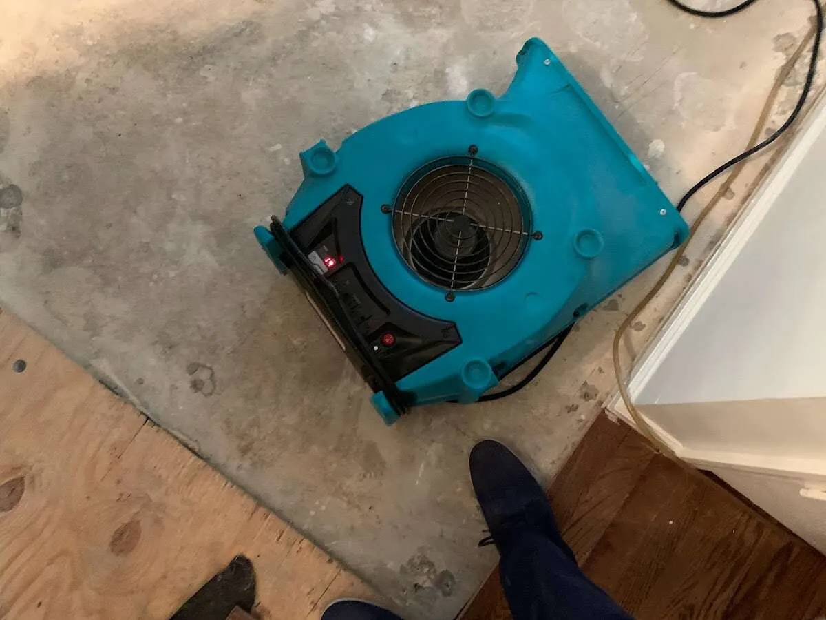 Air mover drying subfloor during Commercial Water Damage Restoration in Manville